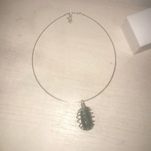 Emerald stone in ringed cage necklace